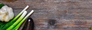 wood background with garlic and leeks